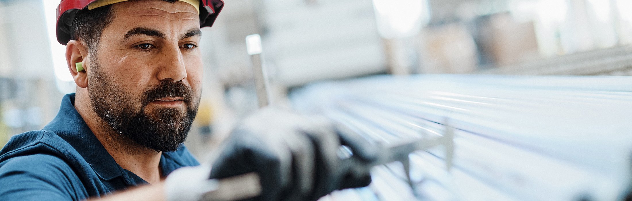 Quality assurance inspector examining steel tubes at Royal Van Leeuwen facility